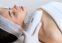 Close-up of a woman relaxing during a facial skin treatment at a clinic