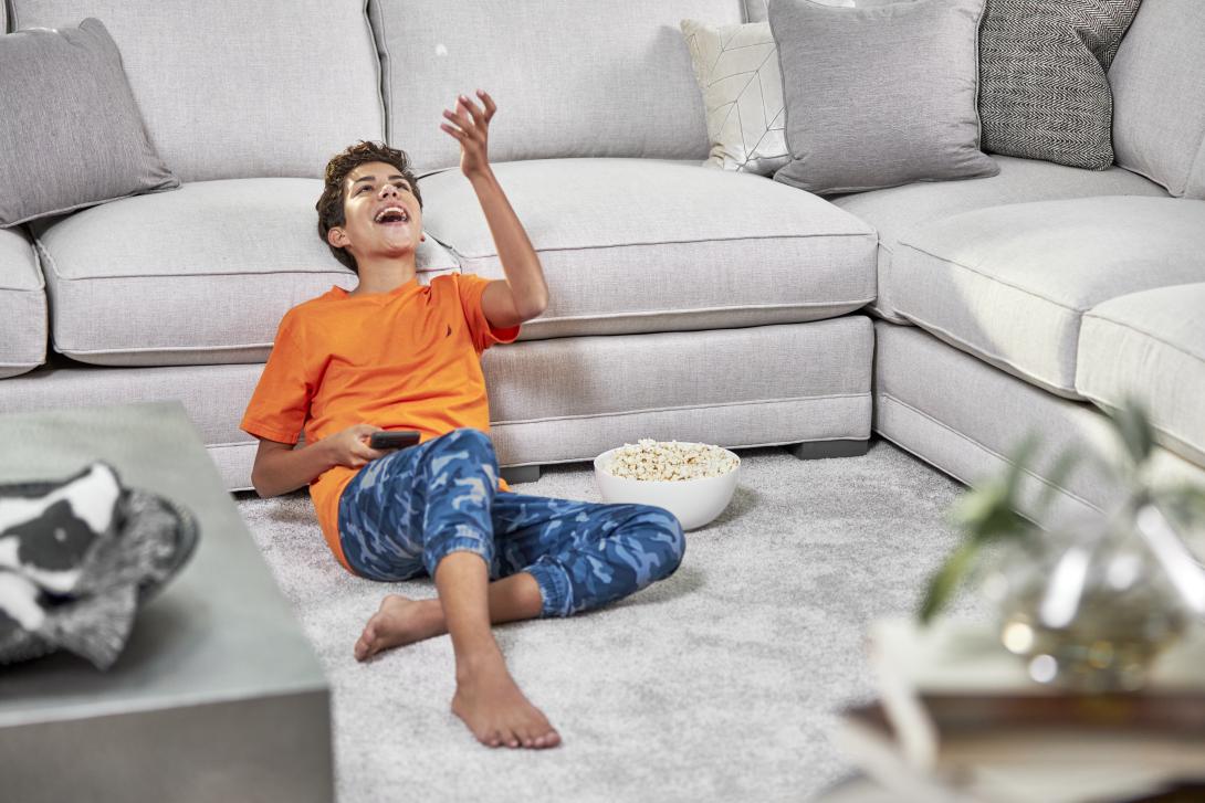 boy sitting by couch after carpet cleaning in the woodlands tx
