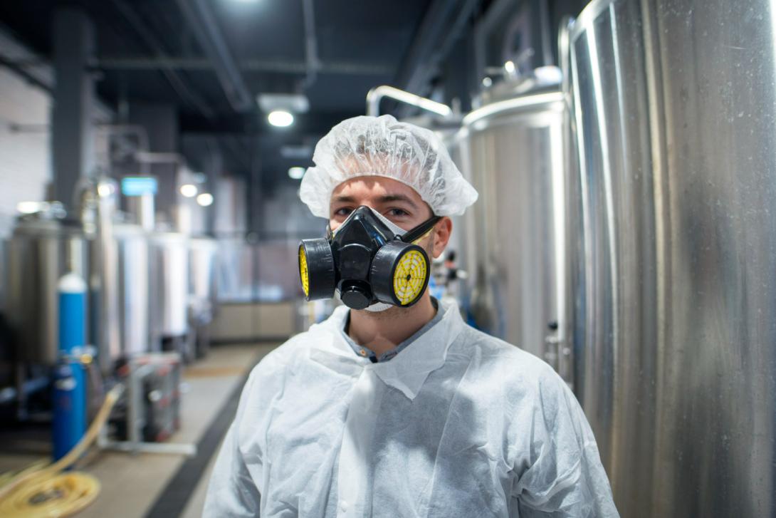 A scientist wearing odour control mask in chemical lab