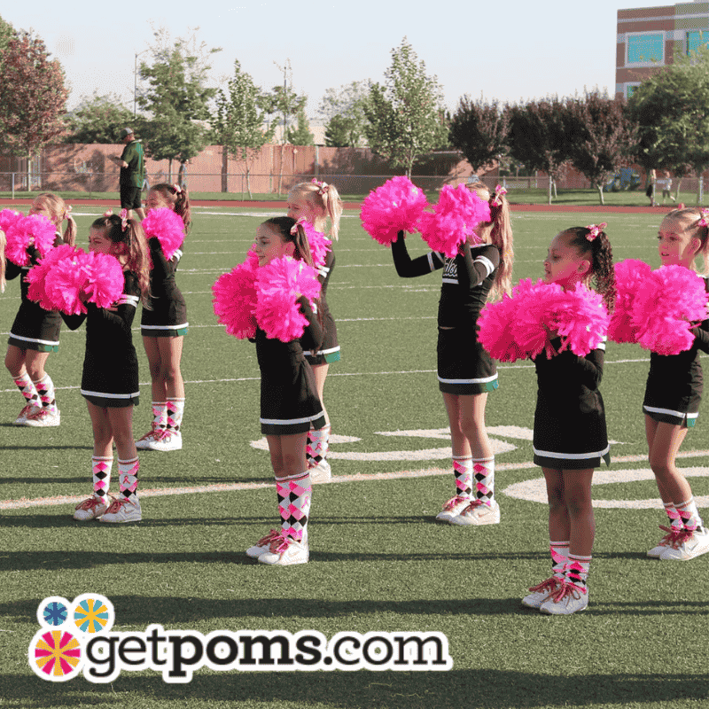 Young girls performing with youth cheer poms