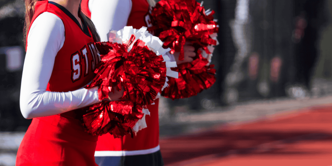 cheerleader raising cheer poms