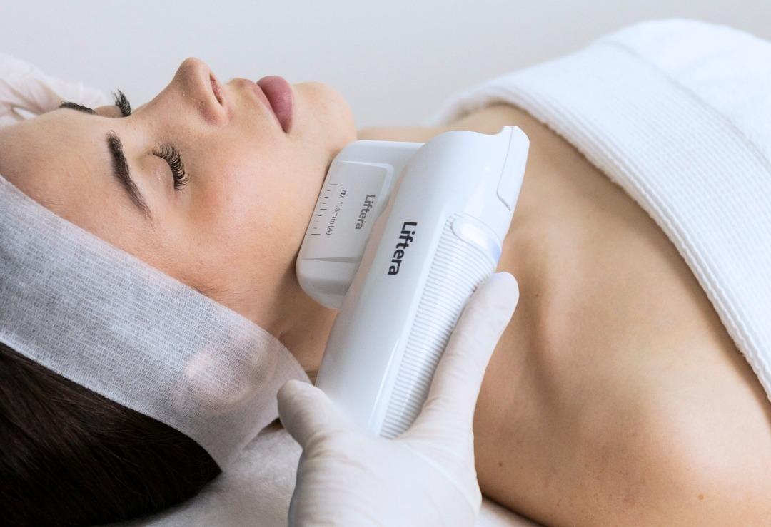 Close-up of a woman relaxing during a facial skin treatment at a clinic
